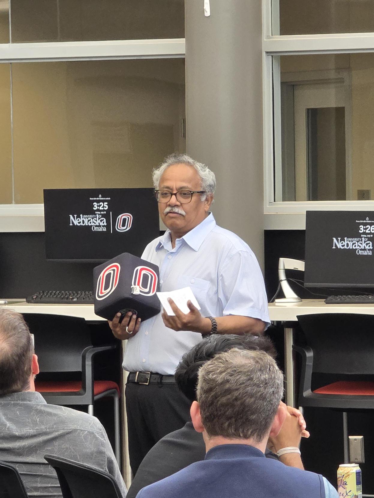 AI-CCORE's Dr. Mahadevan Subramaniam addresses students, mentors, and families.